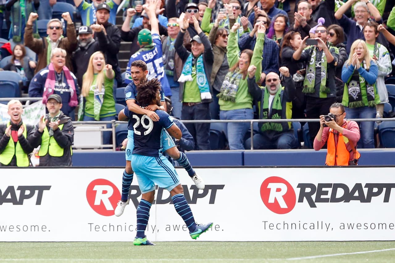 Oct 23, 2016; Seattle, WA, USA; Seattle Sounders FC midfielder Cristian Roldan (7) celebrates his goal with teammate defender Roman Torres (29) after Roldan scored a goal against the Real Salt Lake during the first half at CenturyLink Field. Mandatory Credit: Jennifer Buchanan-USA TODAY Sports