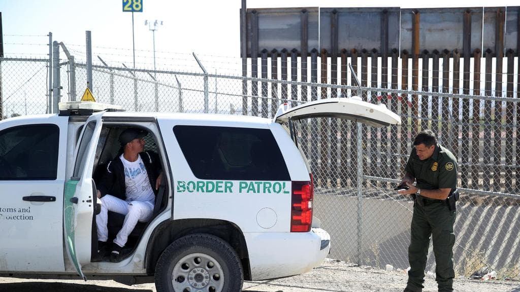 A Border Patrol agent detains an undocumented immigrant in El Paso, Texas.