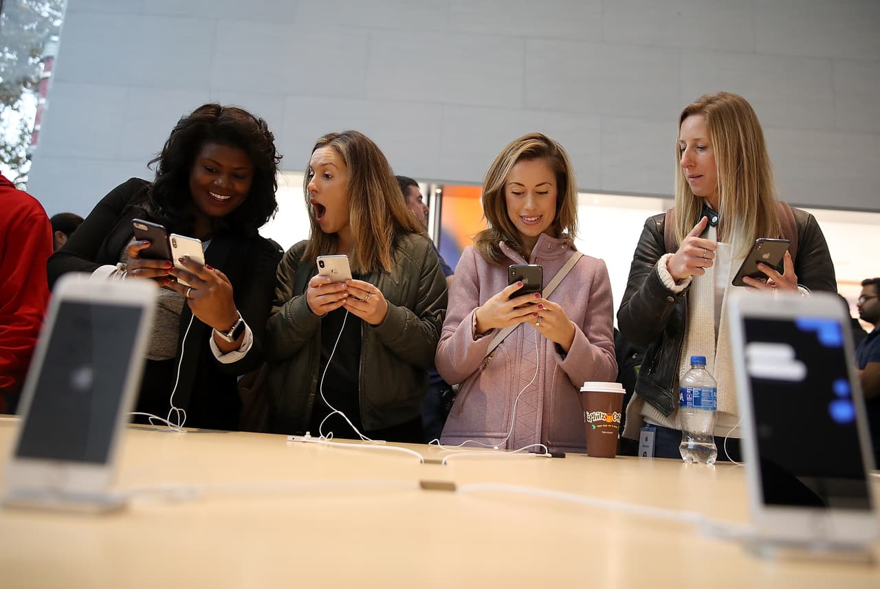 Shoppers examine the new iPhone X at an Apple store in Palo Alto, California, on the launch day of the new phone. November 3, 2017
<br>