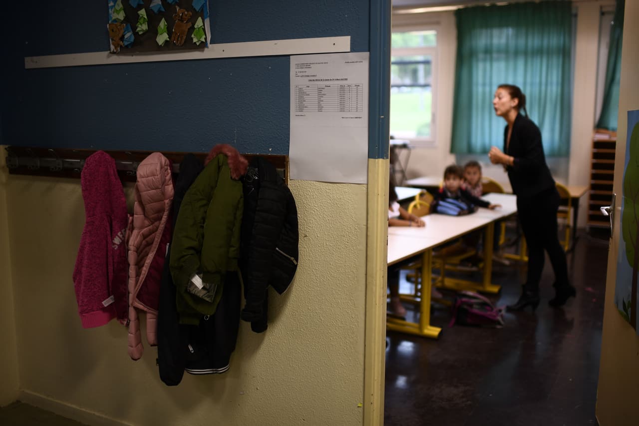 A teacher speaks to pupils in a classroom at their primary school at the start of the new school year on September 4, 2017, in Corbeil-Essonnes, outside Paris. / AFP PHOTO / CHRISTOPHE SIMON (Photo credit should read CHRISTOPHE SIMON/AFP/Getty Images)