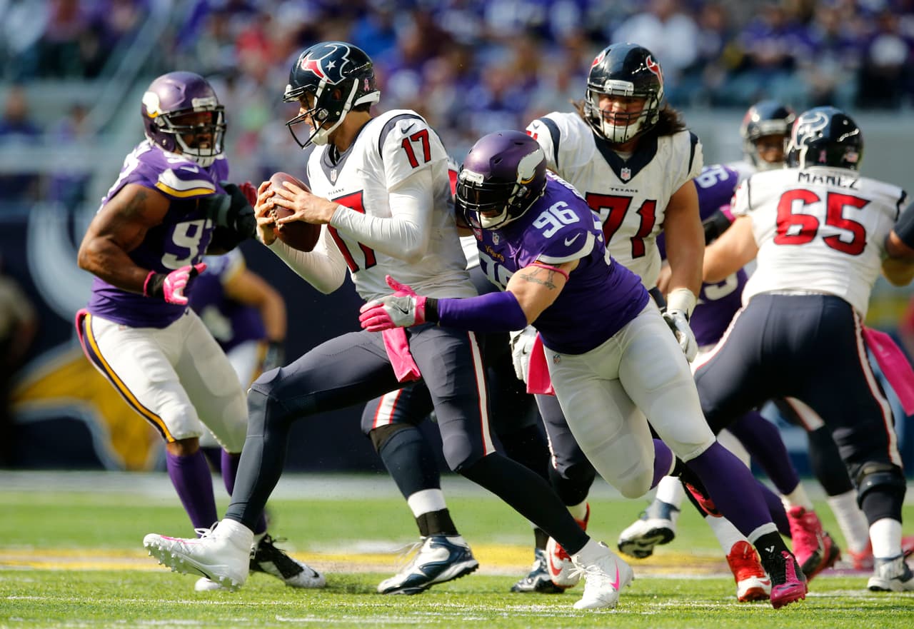 Minnesota Vikings defensive end Brian Robison (96) tries to tackle Houston Texans quarterback Brock Osweiler (17) during the second half of an NFL football game, Sunday, Oct. 9, 2016, in Minneapolis. (AP Photo/Jim Mone)