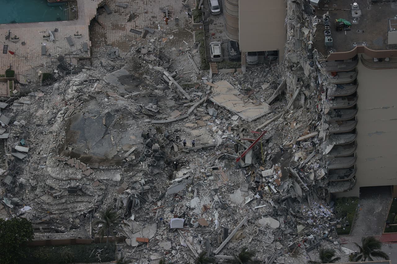 SURFSIDE, FLORIDA - JUNE 24: Search and rescue personnel work in the rubble of the 12-story condo tower that crumbled to the ground during a partially collapse of the building on June 24, 2021 in Surfside, Florida. It is unknown at this time how many people were injured as search-and-rescue effort continues with rescue crews from across Miami-Dade and Broward counties. (Photo by Joe Raedle/Getty Images)