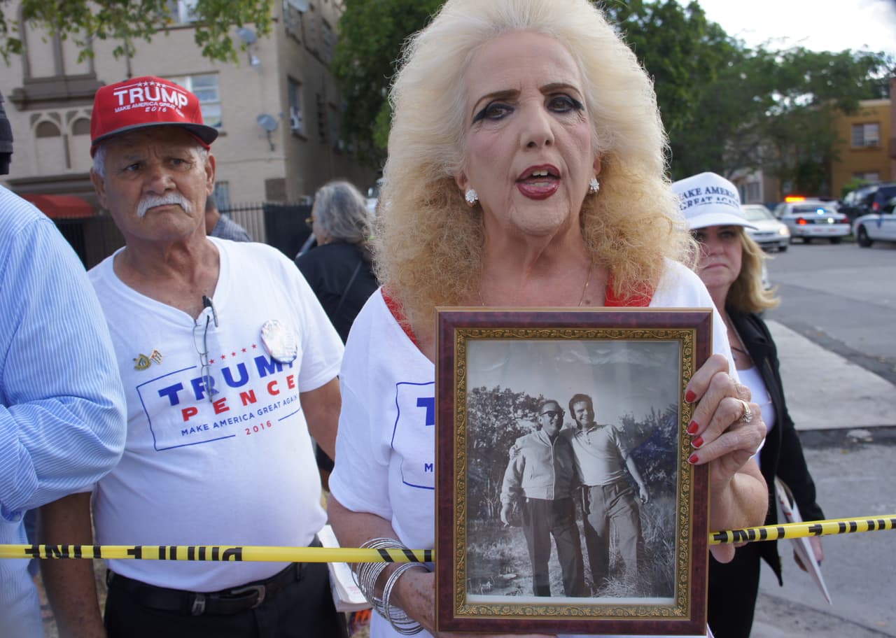 Trump supporter Clara Roteta outside the Republican candidate's meeting with Bay of Pigs veterans, holding a photo of her dad, who participated in the failed 1961 invasion.