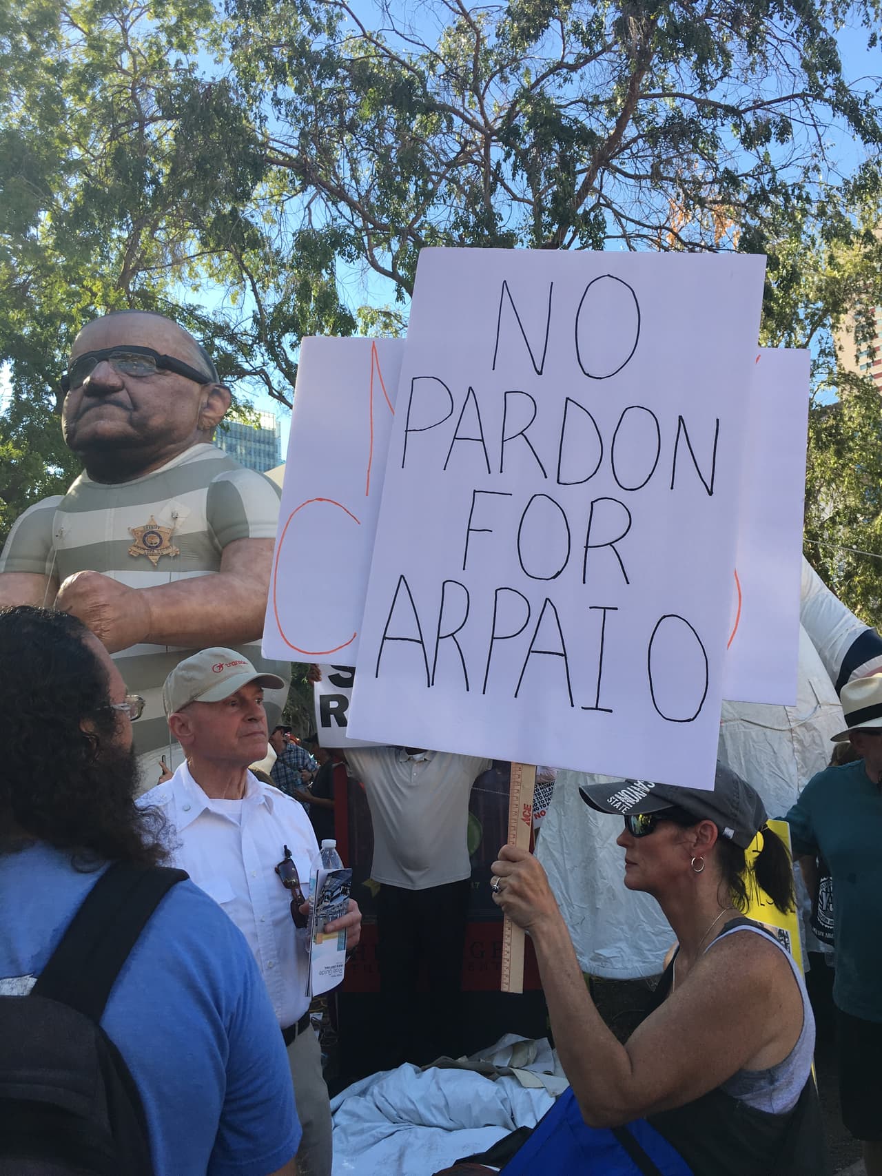 Con un muñeco inflable gigante que representa al exsheriff de Maricopa, Joe Arpaio, decenas de personas rechazaron los rumores de que Trump venía a otorgarle el perdón presidencial. Arpaio fue acusado de desacato por desobedecer la orden de un juez de detener los patrullajes de tráfico en los que se enfocaba en inmigrantes hispanos.
