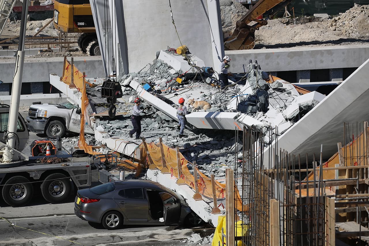 MIAMI, FL - MARCH 15: Miami-Dade Fire Rescue Department personel and other rescue units work at the scene where a pedestrian bridge collapsed a few days after it was built over southwest 8th street allowing people to bypass the busy street to reach Florida International University on March 15, 2018 in Miami, Florida. Reports indicate that there are an unknown number of fatalities as a result of the collapse, which crushed at least five cars. (Photo by Joe Raedle/Getty Images)