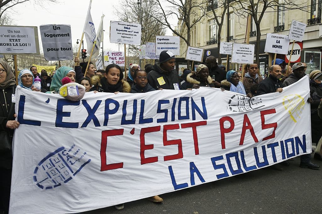 People hold a banner reading ""Exviction is not the solution" during a protest on the place de la Republique square in Paris, called by French Right to Housing association (DAL, Droit au Logement) against evictions on April 2, 2016, a day after the end of the winter truce (housing protection during winter months). / AFP / DOMINIQUE FAGET (Photo credit should read DOMINIQUE FAGET/AFP/Getty Images)