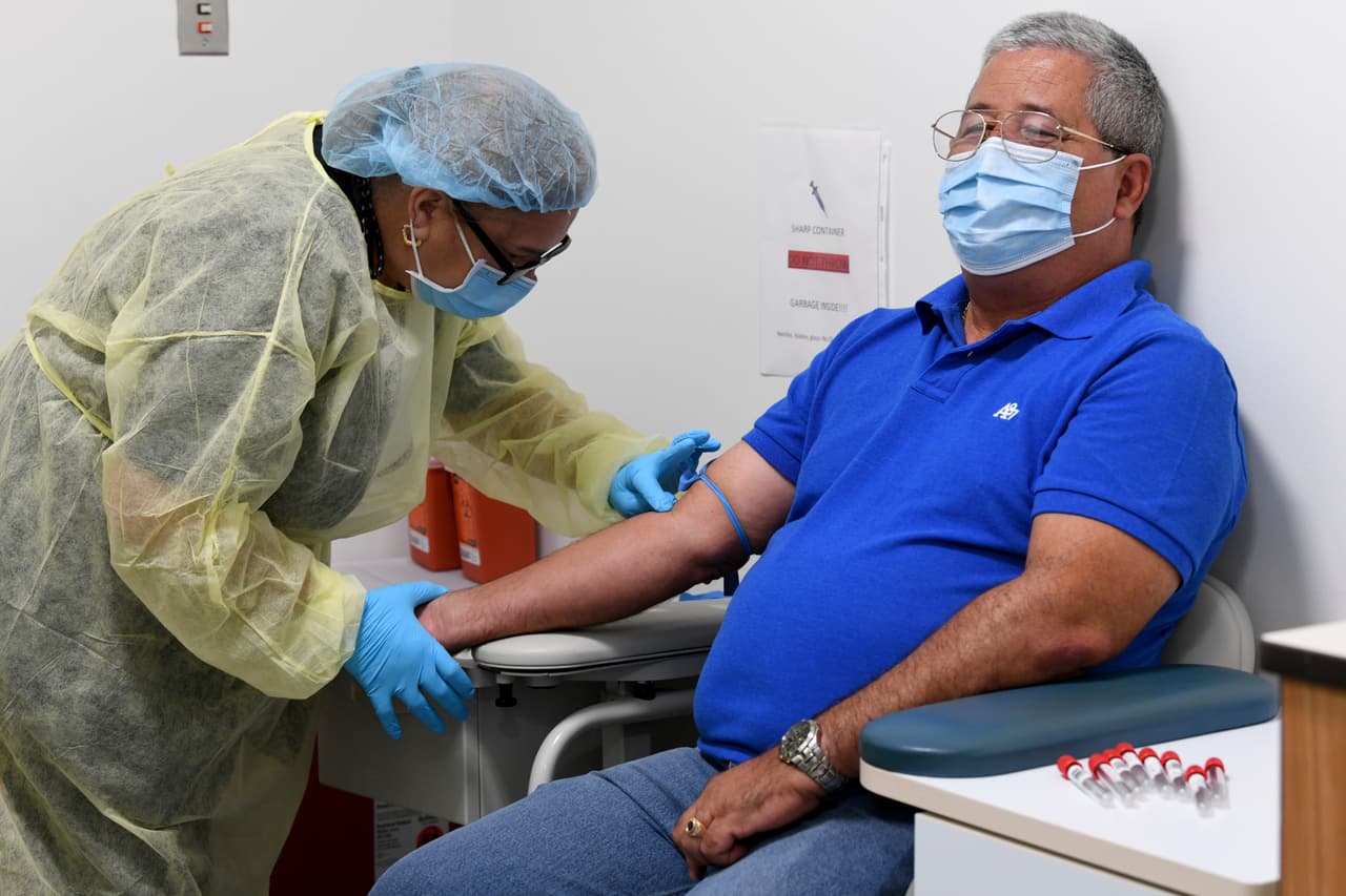 Mayra Fernández, flebotomista de la Facultad de Medicina Miller de la Universidad de Miami, se prepara para tomar una muestra de sangre del participante del estudio Julio Li en Miami.
<br>