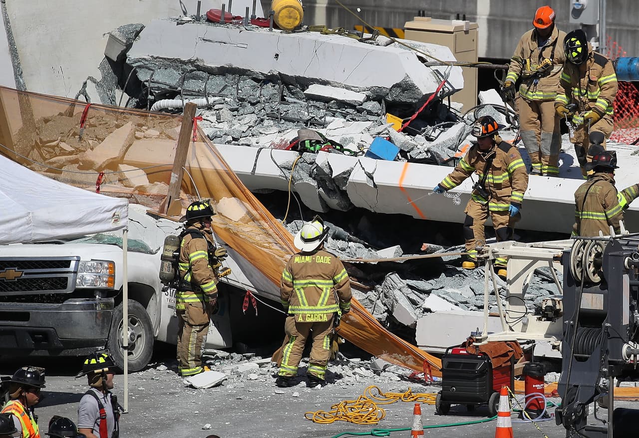 MIAMI, FL - MARCH 15: Miami-Dade Fire Rescue Department personel and other rescue units work at the scene where a pedestrian bridge collapsed a few days after it was built over southwest 8th street allowing people to bypass the busy street to reach Florida International University on March 15, 2018 in Miami, Florida. Reports indicate that there are an unknown number of fatalities as a result of the collapse, which crushed at least five cars. (Photo by Joe Raedle/Getty Images)