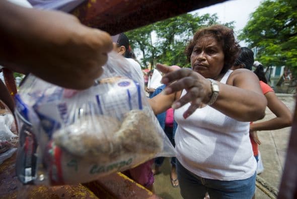"Nos dicen que viene el gobernador a celebrar, nos vamos a distraer un tantito de entre tanta agua", dice Antonio, un pescador de 38 años, mientras sus dos hijos juegan en el agua estancada frente a su casa.