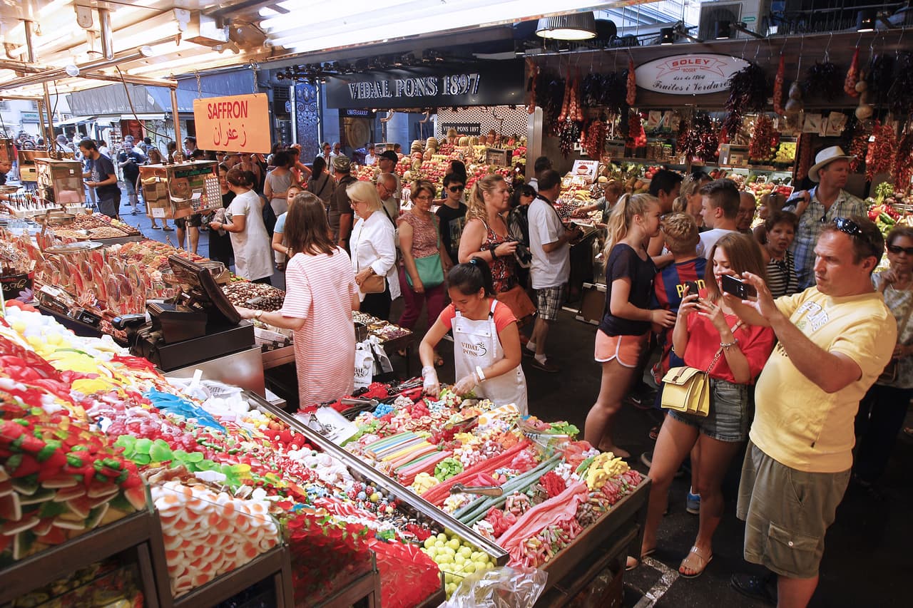 La Boquería es una plaza de mercado que dispone las frutas de manera ordenada y por colores, una plaza que es el santuario de turistas que quieren ver cómo los locales compran el pescado, las frutas de estación y que quieren probar los dulces típicos.