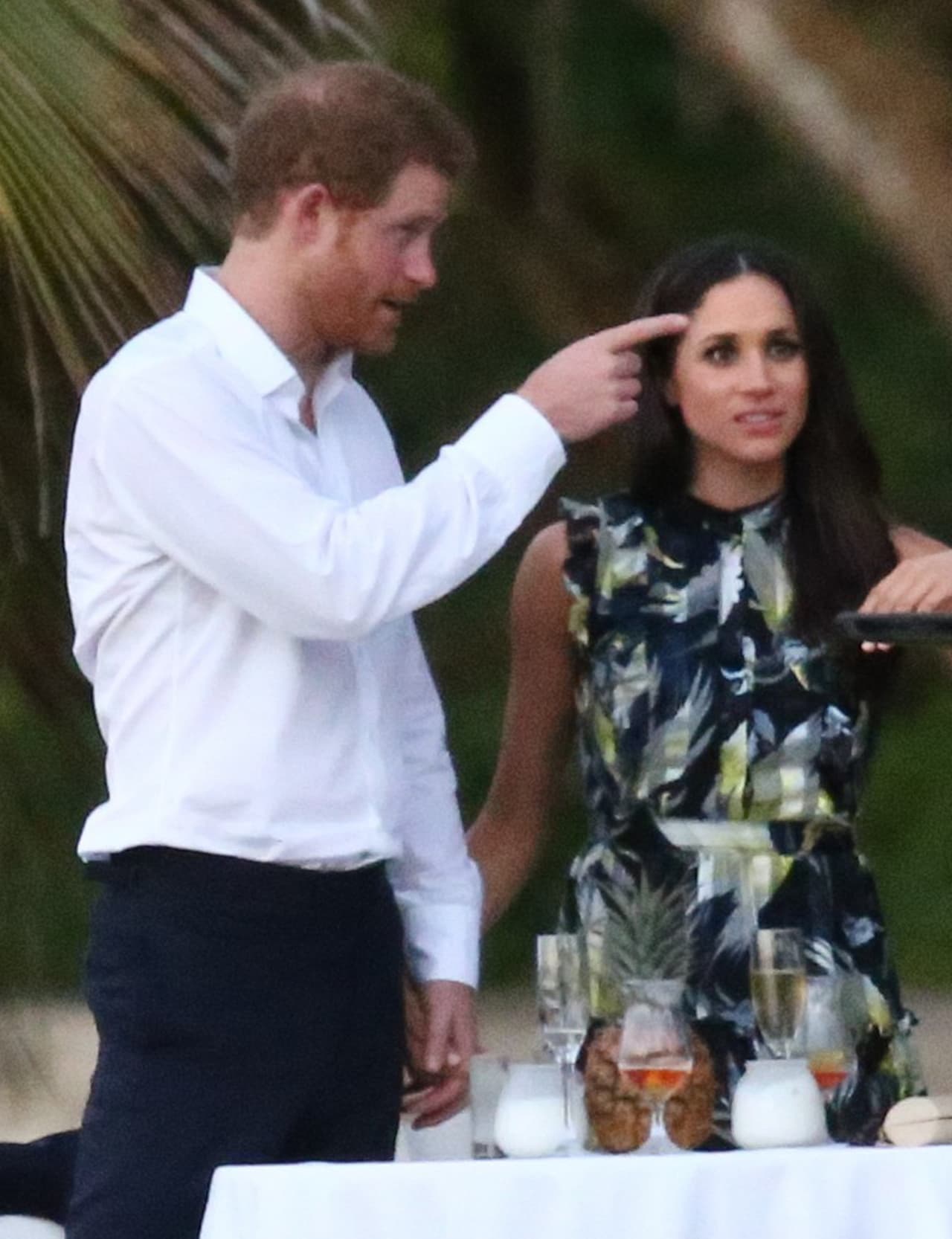 Photo © 2017 Fame Flynet USA/The Grosby Group PREMIUM EXCLUSIVE Jamaica, March 03, 2017 Royal couple Prince Harry and his girlfriend Meghan Markle were spotted attending a friend's wedding. Harry and Meghan enjoyed the festivities with the whole group before breaking off for some private conversation at a small table.