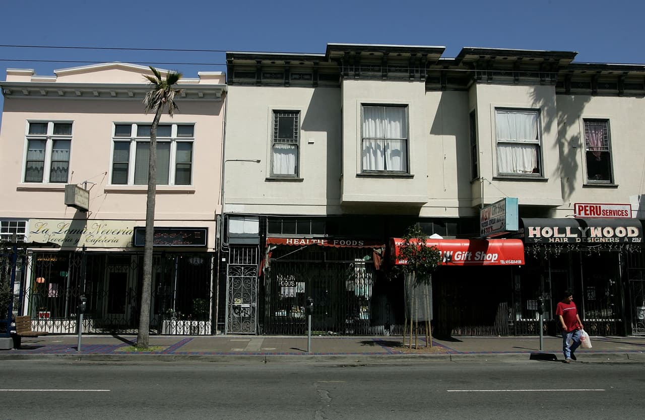 SAN FRANCISCO - MAY 01: People walk by a row of closed businesses in the Mission District as store owners elected to closed their businesses to protest for immigrant rights May 1, 2006 in San Francisco, California. Immigrants and their supporters around the nation are rallying together through marches and demonstrations, along with boycotting work and spending, in a consolidated effort to show their importance throughout American society as the ongoing political debate on immigration reform continues. (Photo by Justin Sullivan/Getty Images)