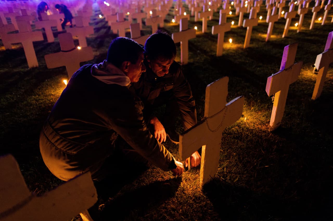 People light candles as they pay respect to Falkland/Malvinas' war fallen soldiers at a memorial in Pilar, Buenos Aires province, Argentina on April 1, 2021. - April 2 marks the 40th anniversary of the war between Argentina and the United Kingdom over the islands. (Photo by Tomas CUESTA / AFP) (Photo by TOMAS CUESTA/AFP via Getty Images)