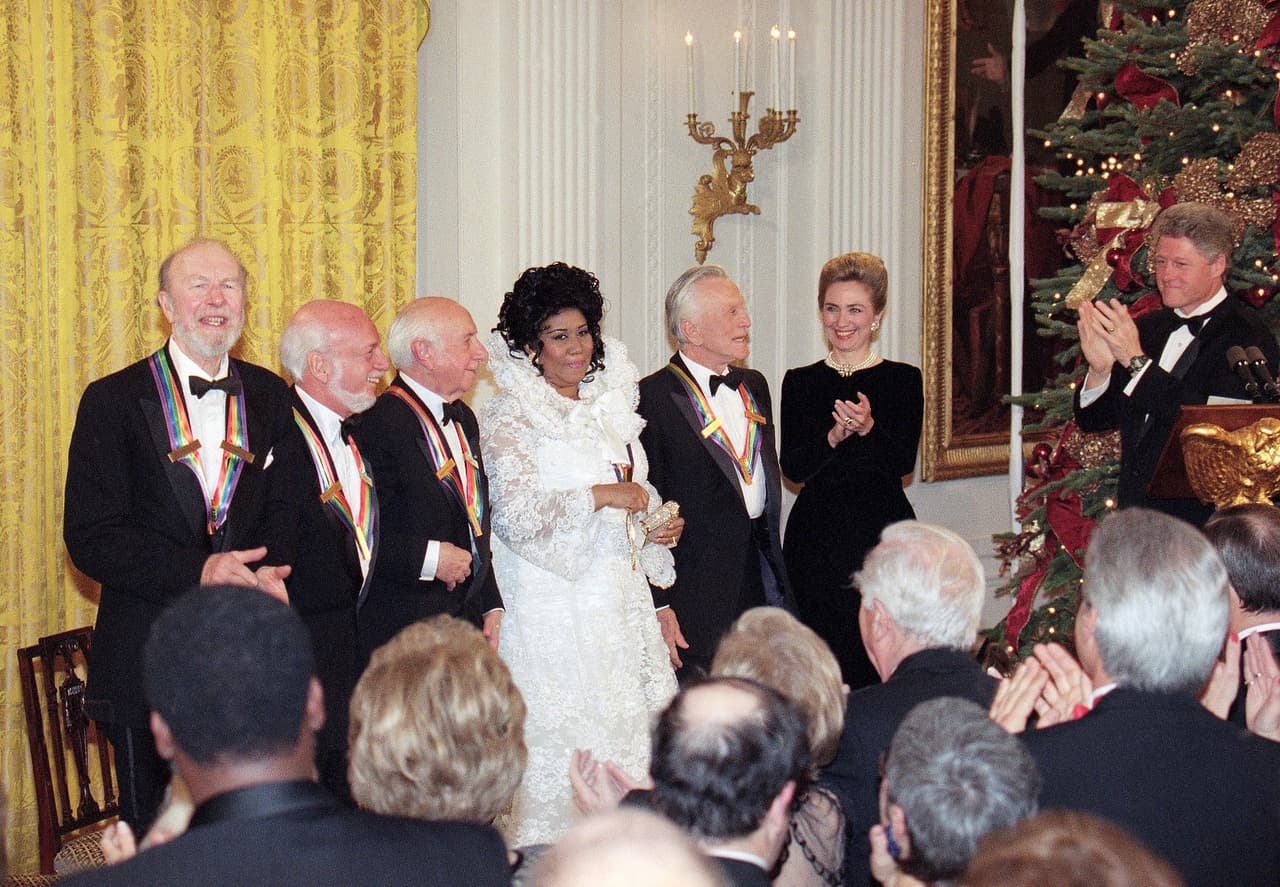 <br>
<br>
<br>FILE - In this Dec. 4, 1994 file photo, President Bill Clinton, from right, and first lady Hillary Rodham Clinton applaud the 1994 Kennedy Center Honors award recipients, from left, songwriter Pete Seeger, director Harold Prince, composer Morton Gould, singer Aretha Franklin and actor Kirk Douglas during a reception in the East Room of the White House. Franklin died Thursday, Aug. 16, 2018 at her home in Detroit. She was 76. (AP Photo/Doug Mills, File)
<br>
<br>
<br>