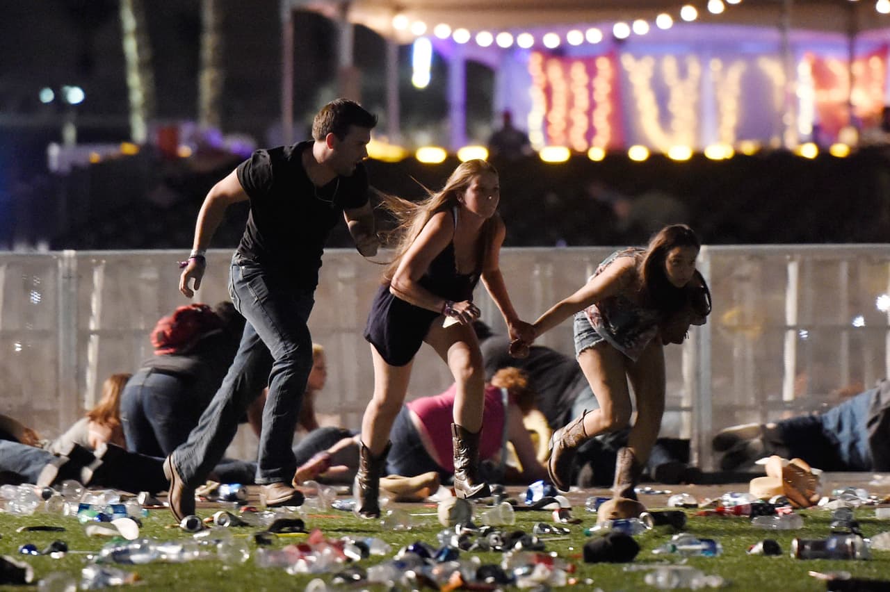 LAS VEGAS, NV - OCTOBER 01: People run from the Route 91 Harvest country music festival after apparent gun fire was hear on October 1, 2017 in Las Vegas, Nevada. A gunman has opened fire on a music festival in Las Vegas, leaving at least 20 people dead and more than 100 injured. Police have confirmed that one suspect has been shot. The investigation is ongoing. (Photo by David Becker/Getty Images)
<br>
