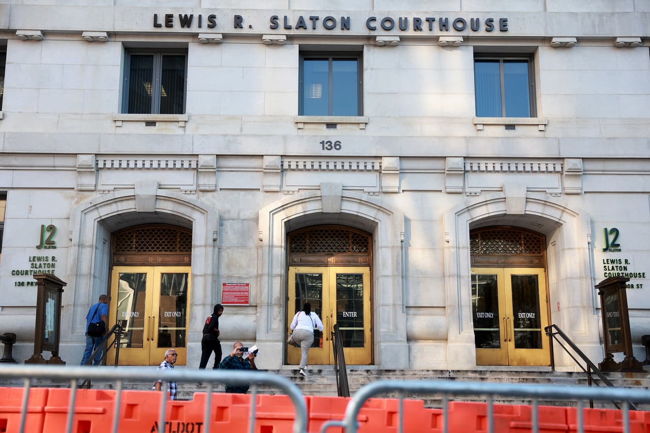 ATLANTA, GEORGIA - AUGUST 07: People enter the Fulton County Courthouse as barricades run along the street on August 07, 2023 in Atlanta, Georgia. The courthouse has more security in place as Fulton County District Attorney Fani Willis is expected to make an announcement soon about a possible grand jury indictment in her investigation into former President Donald Trump and his Republican allies alleged attempt to overturn the 2020 election in the state. (Photo by Joe Raedle/Getty Images)