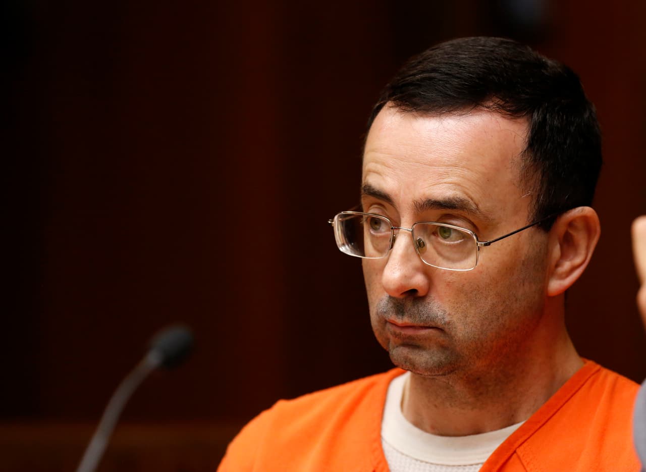Former Michigan State University and USA Gymnastics doctor Larry Nassar is seen in the 55th District Court where Judge Donald Allen Jr. bound him over on June 23, 2017 in Mason, Michigan to stand trial on 12 counts of first-degree criminal sexual conduct. / AFP PHOTO / JEFF KOWALSKY (Photo credit should read JEFF KOWALSKY/AFP/Getty Images)