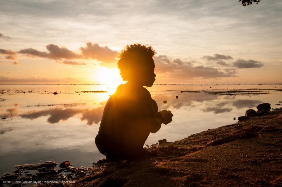 The researchers also identified "dark spots" where fish stock was in worse condition. These places are found across the world, associated with high levels of sea trade, especially where there are ample freezers to store large quantities of fish. In New Ireland, Papua New Guinea, a child washes his clothes on the coast at sunset.