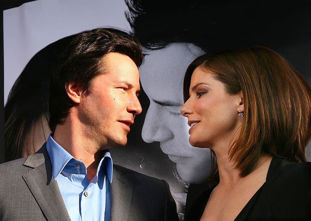 LOS ANGELES - JUNE 13: Actors Keanu Reeves (L) and Sandra Bullock arrive at the premiere of Warner Bros. Pictures' "The Lake House" at the Cinerama Dome on June 13, 2006 in Los Angeles, California. (Photo by Kevin Winter/Getty Images)