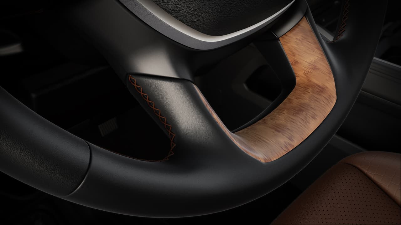 El volante de la RAM 1500 Laramie Longhorn 2019 tiene 
<b>insertos en madera</b> y se pueden apreciar costuras en tono marrón que hacen contraste en el forro del mismo.