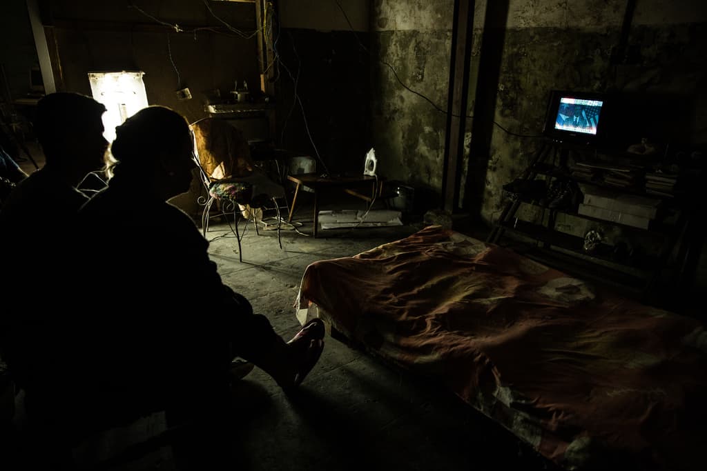 Yohamna Monzón, Edel Feria and their son Emanuel Rodríguez, 16, watch Obama on TV