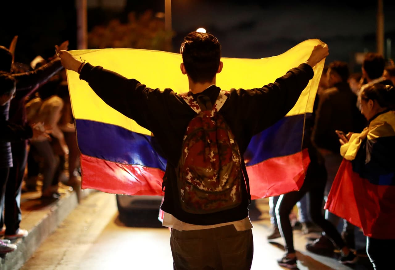 Los jóvenes también salieron a las calles en Colombia a enfrentar 
<b>al gobierno del presidente Iván Duque y dejar saber su desacuerdo con las políticas económicas. </b>En la imagen, un joven levanta una bandera colombiana en una protesta el 27 de noviembre del 2019.
