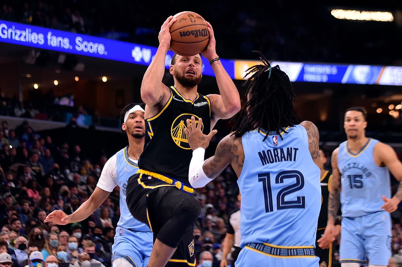 MEMPHIS, TENNESSEE - JANUARY 11: Stephen Curry #30 of the Golden State Warriors goes to the basket against Ja Morant #12 of the Memphis Grizzlies during the first half at FedExForum on January 11, 2022 in Memphis, Tennessee. NOTE TO USER: User expressly acknowledges and agrees that, by downloading and or using this photograph, User is consenting to the terms and conditions of the Getty Images License Agreement. (Photo by Justin Ford/Getty Images)