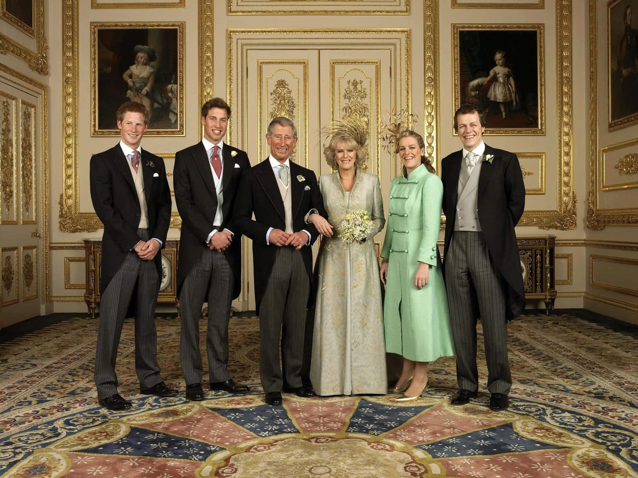 Britain's Prince of Wales and his wife Camilla have selected this family photograph taken at their wedding last April for their 2005 Christmas card. The photograph features Charles' sons, Prince Harry, (far left) and Prince William (2nd L), Camilla's children Laura (2nd R) and Tom Parker Bowles, (far right) gathered around Charles and Camilla in the White Drawing Room at Windsor Castle, west of London. It is the first time Camilla has appeared on Charles' Christmas card. /WPA POOL/PA (Photo credit should read HUGO BURNAND/AFP/Getty Images)