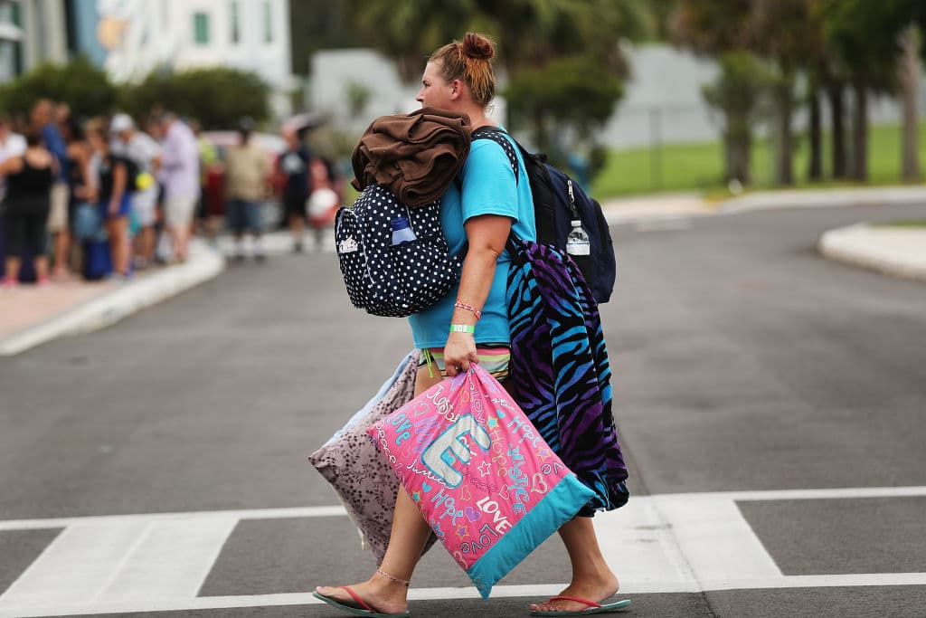 FORT MYERS, FL - SEPTEMBER 09: People arrive at a shelter at Alico Arena where thousands of Floridians are hoping to ride out Hurricane Irma on September 9, 2017 in Fort Myers, Florida. The Fort Myers area could begin to feel hurricane-force winds from Irma by 11 a.m. Sunday and experience wind gusts over 100 mph from Sunday through Monday. (Photo by Spencer Platt/Getty Images)