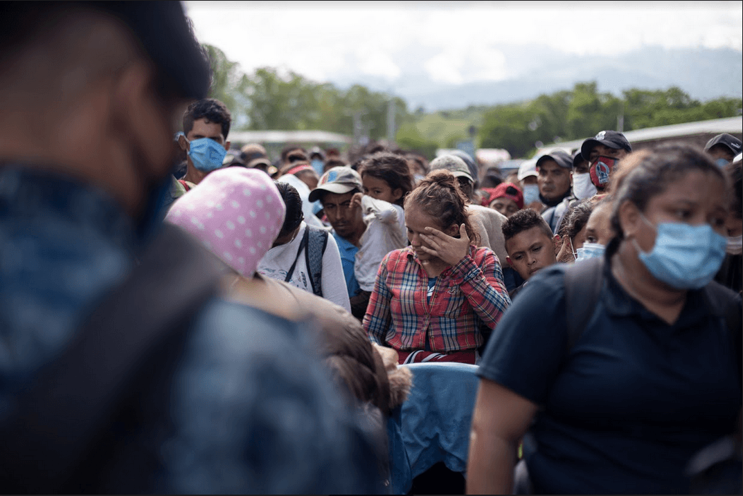 A young woman cries at the Corinto border crossing between Honduras and Guatemala, begging to be allowed to enter Guatemala along with a laggard group of migrants in a caravan that fled Honduras in the middle of the pandemic, headed for the United States. The caravan dissolved in Guatemala. Puerto Barrios, Guatemala, October 1, 2020.