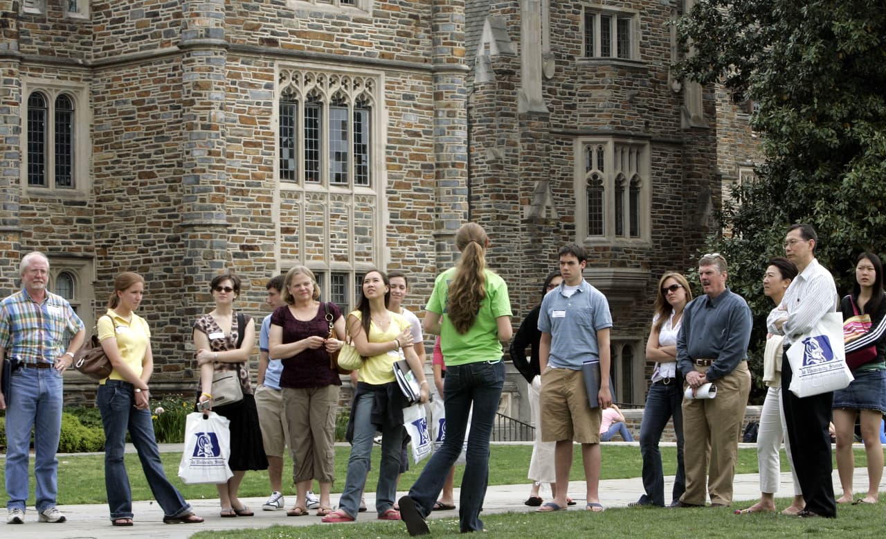 Potential students and their parents take a tour of campus at Duke University during Blue Devil Days, Monday, April 24, 2006, in Durham, N.C. More than 19,000 high school students applied to Duke for next fall, and the highly selective university offered only about 3,800 a spot in the freshman class. School officials mentioned the allegations briefly during the Blue Devil Days welcome sessions, said Susan Coon, Duke assistant director of admissions. She said few have asked directly about the issue during the question-and-answer sessions with the university's vice president of student affairs that end the day. (AP Photo/Gerry Broome)