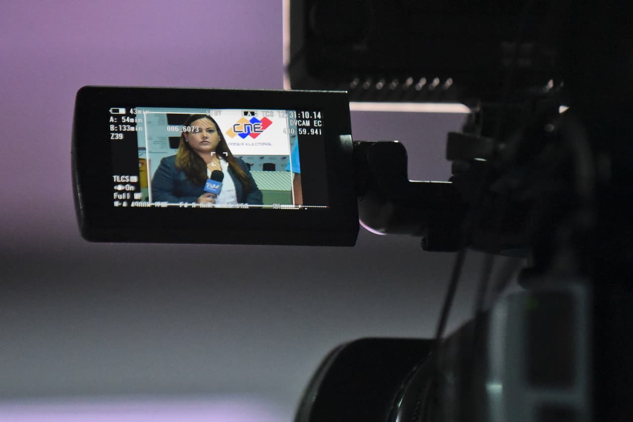A television journalist makes a presentation inside the National Electoral Council (CNE) media room in Caracas, on December 5, 2015. For the first time in 16 years of "Bolivarian revolution" under late president Hugo Chavez and his successor Nicolas Maduro, polls show their rivals could now win a majority in the National Assembly. AFP PHOTO / LUIS ROBAYO / AFP / LUIS ROBAYO (Photo credit should read LUIS ROBAYO/AFP/Getty Images)