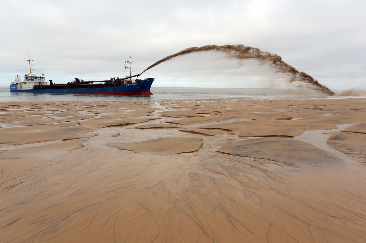 The dredger "Cotes de Bretagne" shoots sand onto a beach of Pyla-sur-Mer in La Teste-de-Buch in Arcachon Bay. The boat, from Brittany, pumps sand from offshore sand bars before shooting it back onto beaches using a technique known as "the rainbow", in an effort to fight against erosion. / AFP / NICOLAS TUCAT (Photo credit should read NICOLAS TUCAT/AFP/Getty Images)