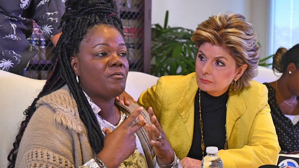 Essie Grundy (L) sits beside attorney Gloria Allred as they announce their race discrimination lawsuit against retail giant Walmart in Los Angeles, California on January 26, 2018. Essie claims that on a shopping trip to her local Walmart she discovered that all the hair products used specifically by African Americans were locked away in glass anti-theft cabinets, whereas all hair products used by others were left on open shelves. / AFP PHOTO / Mark RALSTON (Photo credit should read MARK RALSTON/AFP/Getty Images)