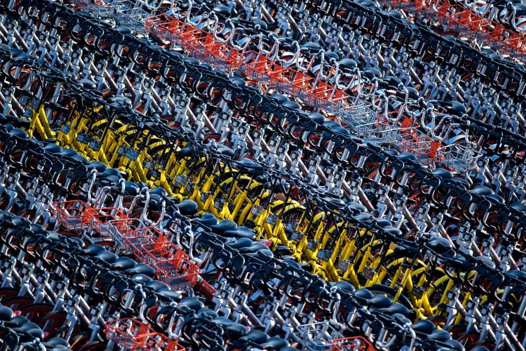 This picture taken on March 1, 2017 shows impounded bicycles from the bike-sharing schemes Mobike and Ofo in Shanghai. Shanghai has impounded thousands of brightly coloured bikes placed on city streets by cycle-sharing companies, in the latest sign of impatience with an explosion of the haphazardly-parked two-wheelers. / AFP PHOTO / Johannes EISELE (Photo credit should read JOHANNES EISELE/AFP/Getty Images)