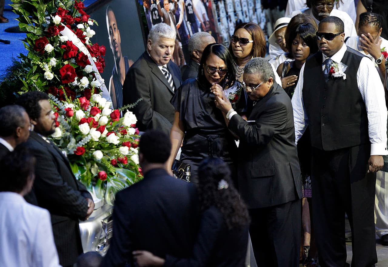 FILE - In this Aug. 4, 2010, file photo, Sherra Wright, the ex-wife of slain NBA basketball player Lorenzen Wright, grieves at the casket of Lorenzen Wright during a memorial service at the FedExForum in Memphis, Tenn. Authorities said Saturday, Dec 16, 2017, that Sherra Wright was charged with first-degree murder in the death of her ex-husband. (AP Photo/Lance Murphey, File)
