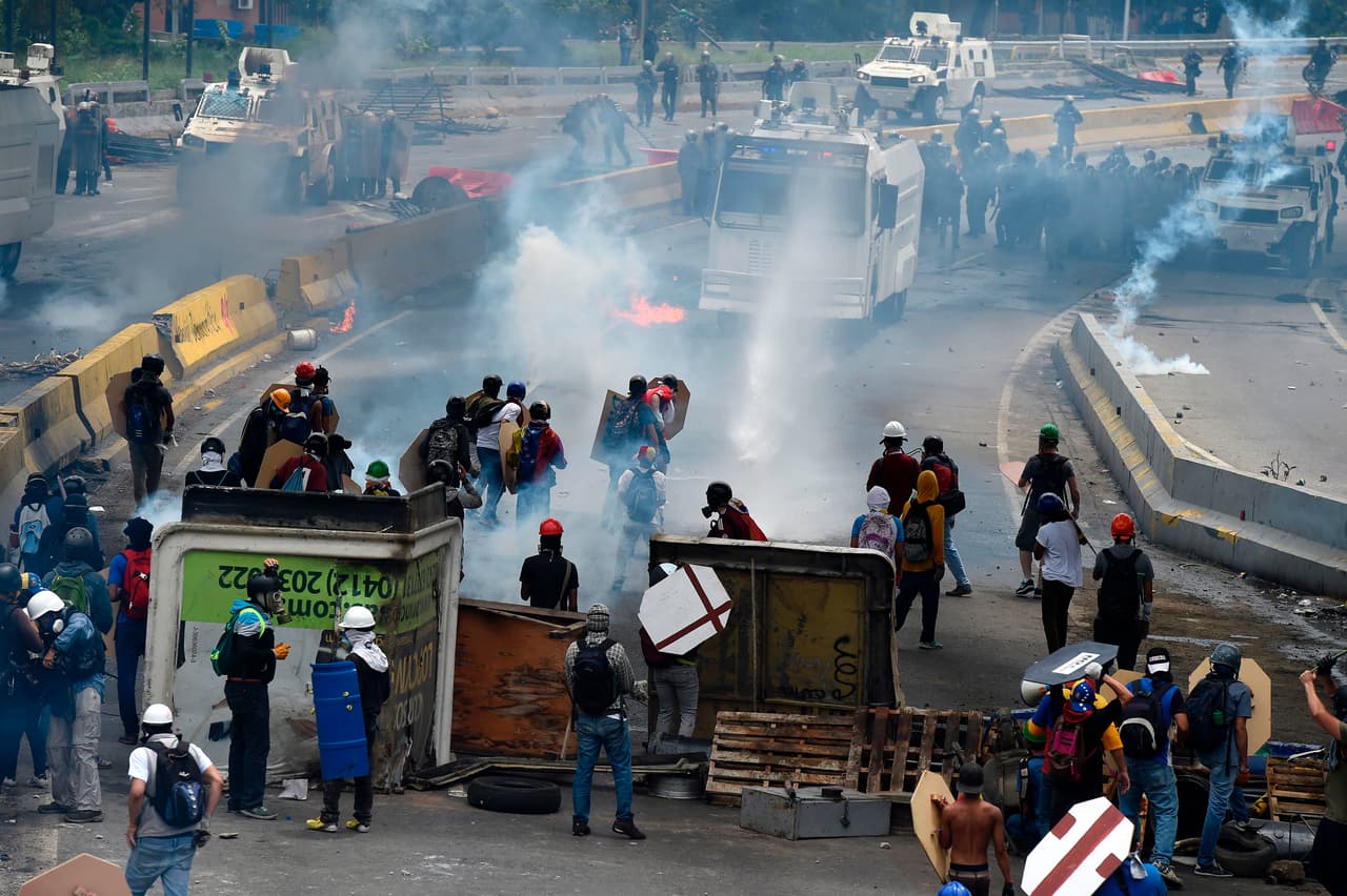 Clash on the front lines of the Caracas protests: on one side oppostion demonstrators; on the other, police and National Guard.