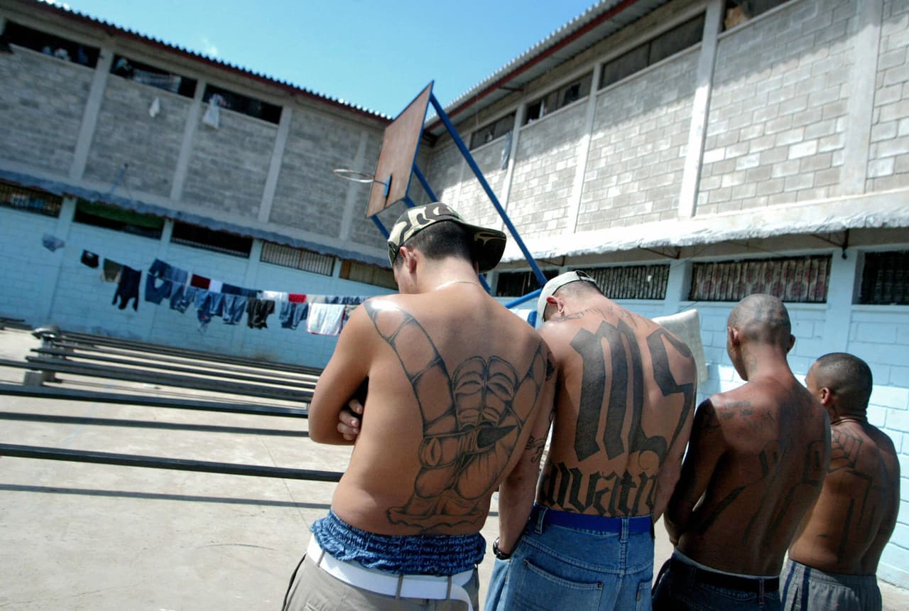 Tegucigalpa, HONDURAS: Four unidentified members of the Mara Salvatrucha "MS-13" (juvenile gang) show their tatoos in the unit where they are kept imprisioned in the National Penitentiary in Tamara, 30km north of Tegucigalpa, 01 February 2006. AFP PHOTO/Elmer MARTINEZ (Photo credit should read ELMER MARTINEZ/AFP/Getty Images)