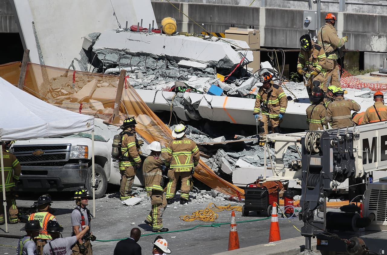 MIAMI, FL - MARCH 15: Miami-Dade Fire Rescue Department personel and other rescue units work at the scene where a pedestrian bridge collapsed a few days after it was built over southwest 8th street allowing people to bypass the busy street to reach Florida International University on March 15, 2018 in Miami, Florida. Reports indicate that there are an unknown number of fatalities as a result of the collapse, which crushed at least five cars. (Photo by Joe Raedle/Getty Images)