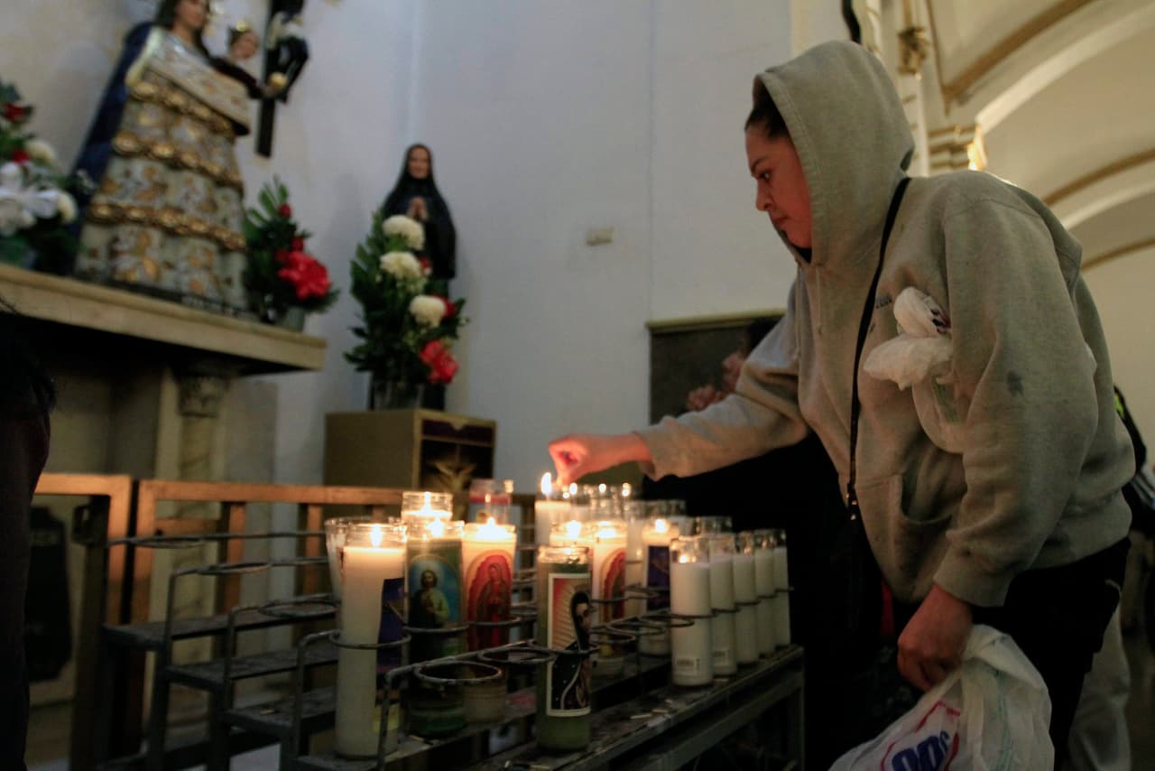 Con velas esta mujer le muestra su devoción y su fe.