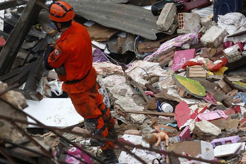 Bomberos trabajan en el lugar donde una explosión derribó una edificación de dos pisos