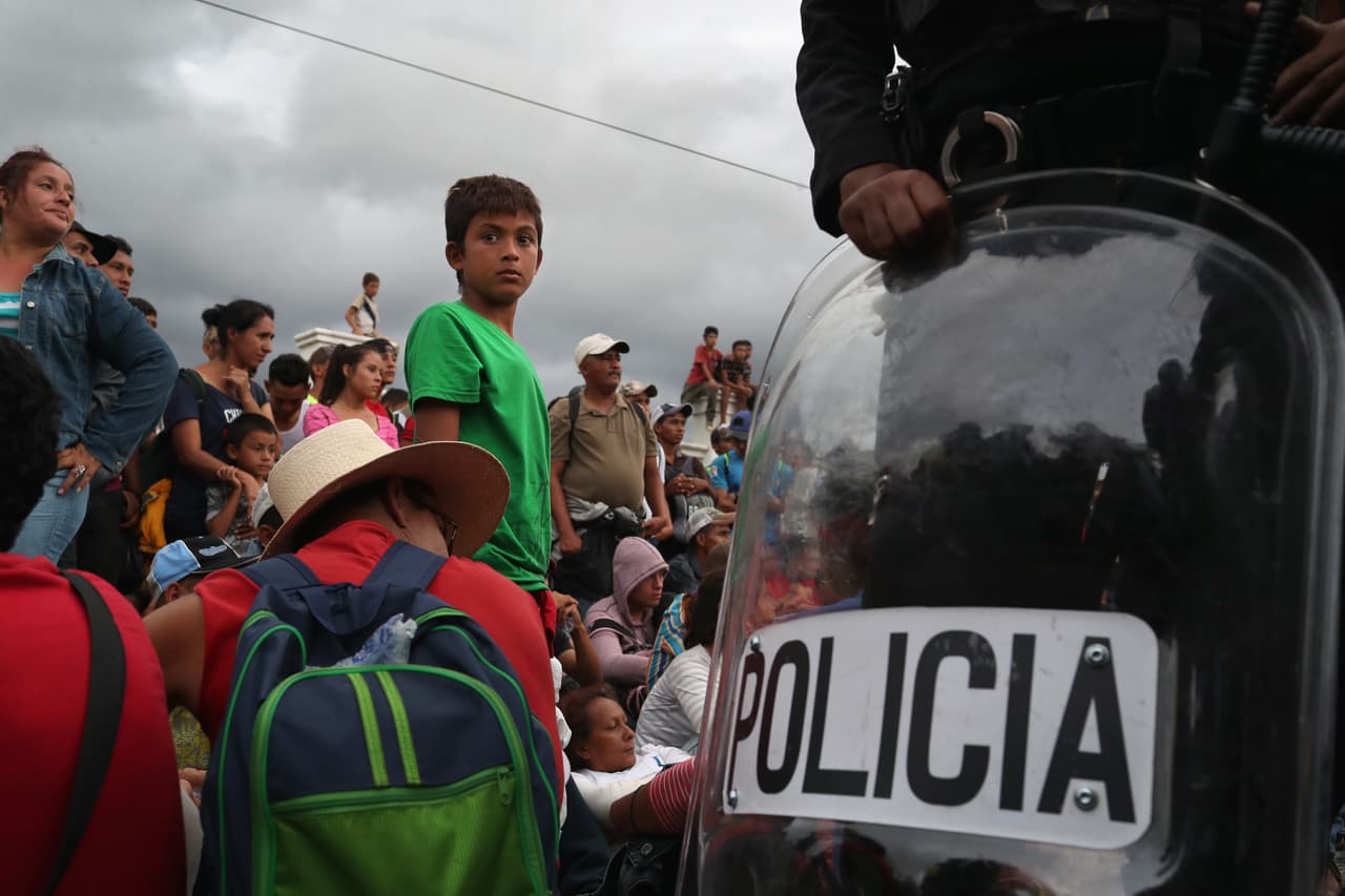 ESQUIPULAS, GUATEMALA - OCTOBER 15: A caravan of more than 1,500 Honduran migrants pauses at a Guatemalan police checkpoint after crossing the border from Honduras on October 15, 2018 in Esquipulas, Guatemala. The caravan, the second of 2018, began Friday in San Pedro Sula, Honduras with plans to march north through Guatemala and Mexico en route to the United States. Honduras has some of the highest crime and poverty rates in Latin America. (Photo by John Moore/Getty Images)