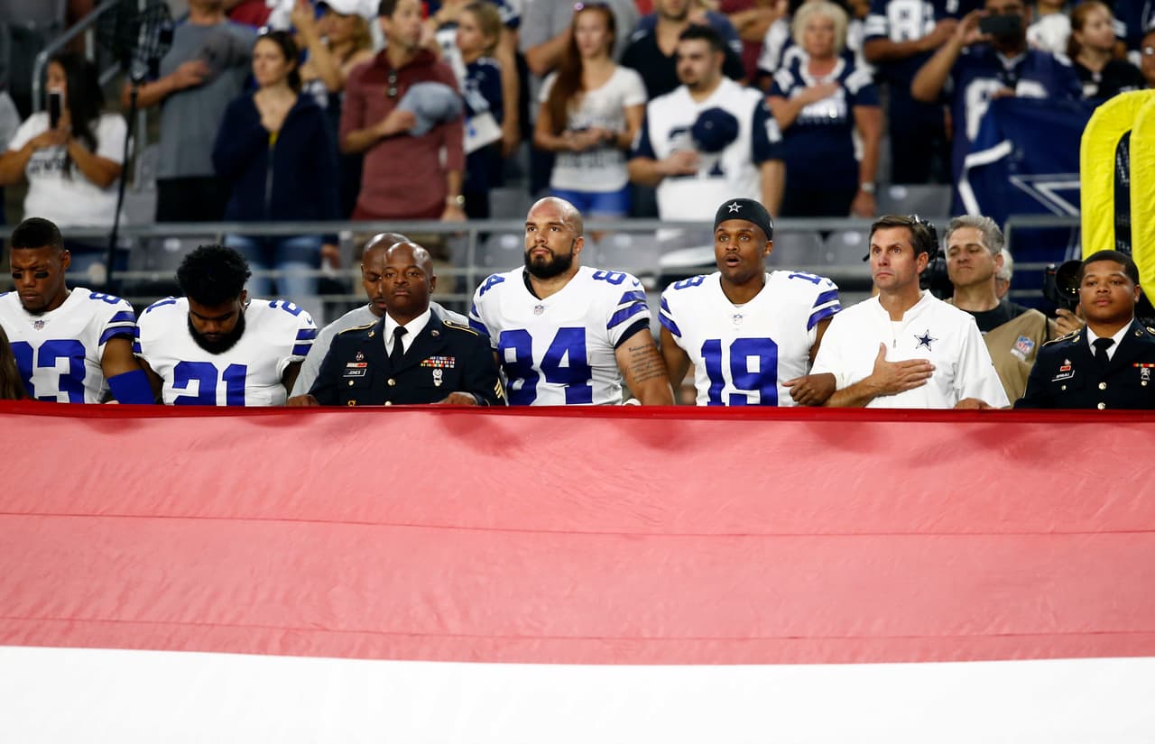 The Dallas Cowboys stand during the national anthem prior to an NFL football game against the Arizona Cardinals, Monday, Sept. 25, 2017, in Glendale, Ariz. (AP Photo/Ross D. Franklin)