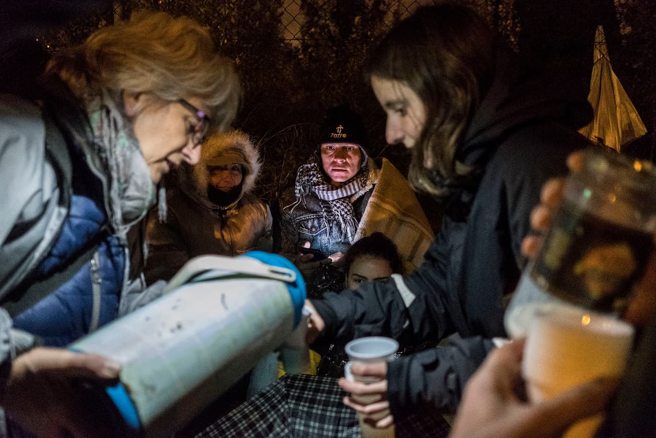 Volunteers from the Solidarity Welcome Network and the Self Help House of Aluche (CABA) offer hot coffee to people spending the night queuing outside the Madrid immigration office.