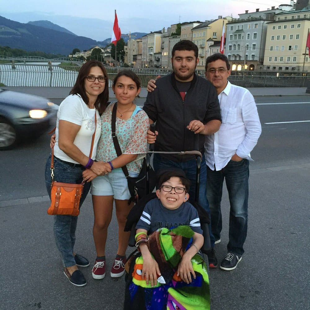 In this summer 2016 photo provided by Maria Elena Cardenas shows her, far left, and her husband Gustavo Cardenas, far right, with their children Maria, left, Gus, right, and Sergio, below, as they vacation in Austria. Since Venezuela's government arrested Gustavo and five other Citgo employees in November 2017 in Caracas, their 18-year-old son Sergio, who suffers from a rare metabolic disease called mucolipidosis, has been having panic attacks and screaming at night for his Dad. Maria fears that he could die before his father’s release.