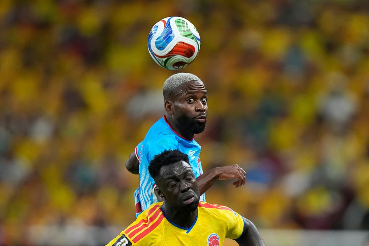 El congoleño Cedric Bakambu (arriba) disputa el balón con el colombiano Davinson Sánchez durante el partido de fútbol del Grupo K de la Copa del Mundo entre Colombia y el Congo en Zapopan, cerca de Guadalajara, México, el martes 23 de junio de 2026.