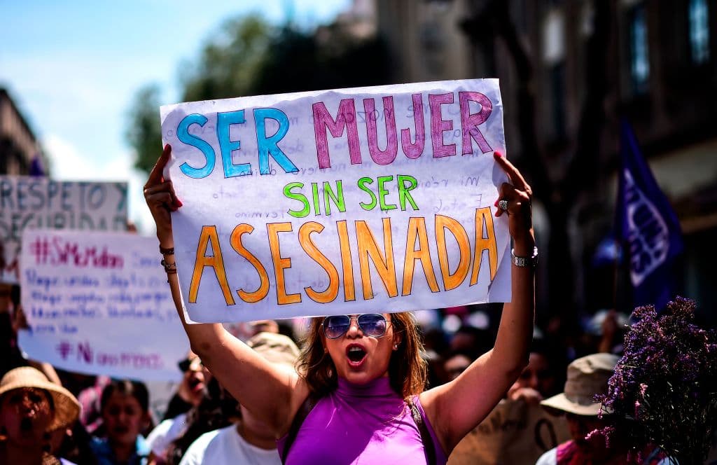 A Mexican woman holding a sign reading "To be a woman without being murdered" takes part in a protest against murders and other violence against women in Mexico City on September 17, 2017. The protest was triggered by the murder of 19-year-old Mara Castilla, who was allegedly killed by a taxi driver on September 8, in the southern state of Puebla. / AFP PHOTO / RONALDO SCHEMIDT (Photo credit should read RONALDO SCHEMIDT/AFP/Getty Images)