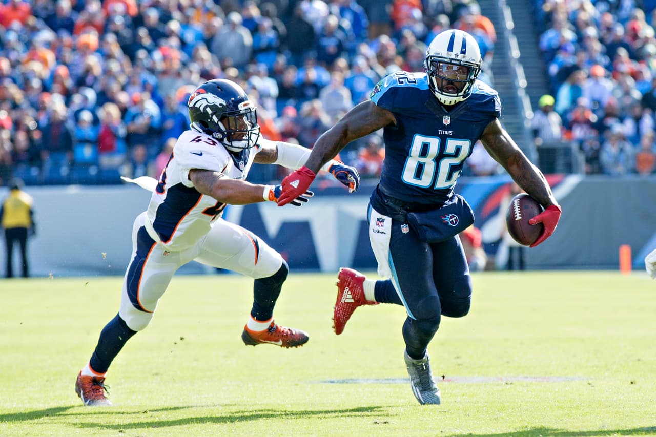 NASHVILLE, TN - DECEMBER 11: Delanie Walker #82 of the Tennessee Titans runs the ball after catching a pass and avoids T.J. Ward #43 of the Denver Broncos at Nissan Stadium on December 11, 2016 in Nashville, Tennessee. The Titans defeated the Broncos 13-10. (Photo by Wesley Hitt/Getty Images)