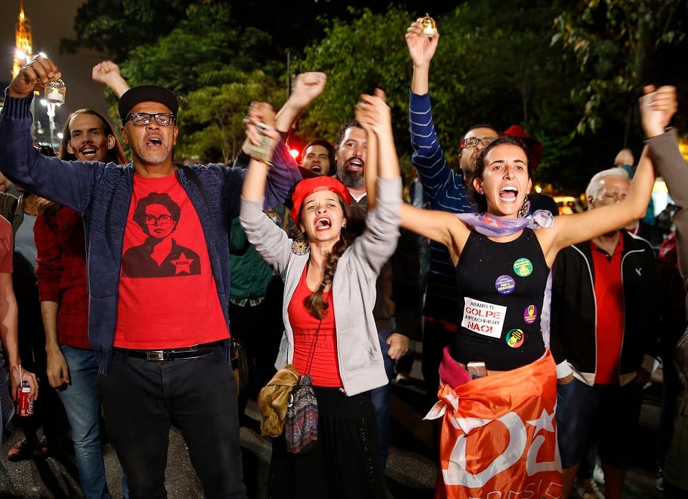 Manifestantes gritan consignas a favor del gobierno durante una vigilia en apoyo de Rousseff en Sao Paulo. Algunos partidarios de la presidenta ocuparon carreteras y autovías, bloquearon accesos a universidades y quemaron neumáticos.