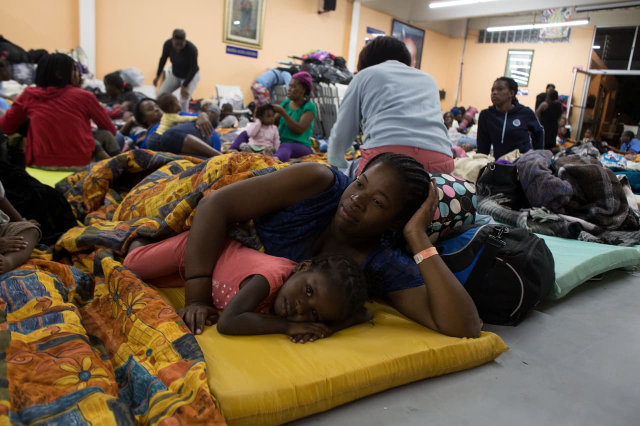 Una una oleada de miles de migrantes llegaron a la frontera en los últimos meses del gobierno del expresidente Barack Obama con la esperanza de lograr asilo en Estados Unidos. Tijuana se vio desbordada y aunque el gobierno hizo poco para ayudar, una serie de grupos cristianos abrieron refugios con camas improvisadas, tiendas de campaña e instalaciones sanitarias. En uno de estos refugios descansa en el suelo Wilenda Nicolas, migrante haitiana. 6 de Octubre de 2016.